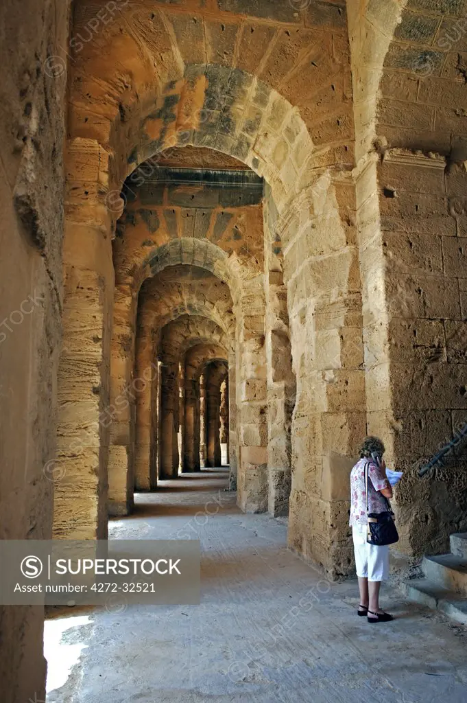 Tunisia, El Jem.A tourist in the Roman amphitheatre of El Jem which dates from the 3rd century AD.