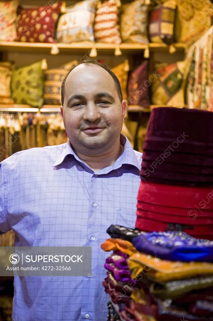 A trader sells fabrics in the Grand Bazaar, Istanbul.