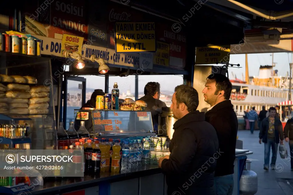 A street stall on the waterfront at Eminonu caters to passengers as they disembark from ferries arriving from ther Asian shore, Istanbul, Turkey
