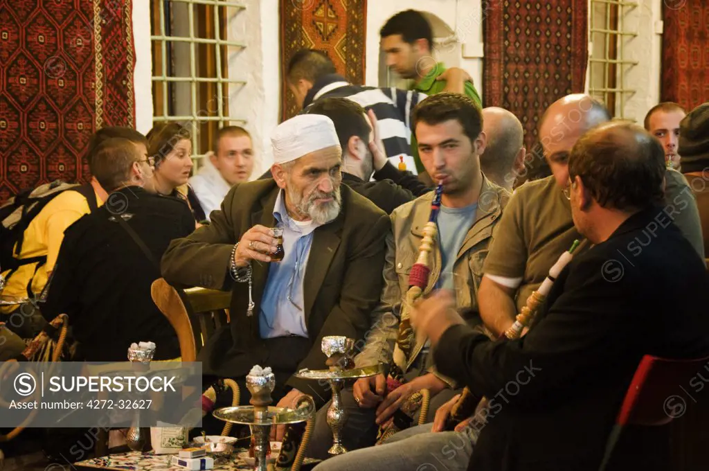 Men smoking nargileh and taking tea at Corlulu Alipasa Medresesi. Istanbul, Turkey