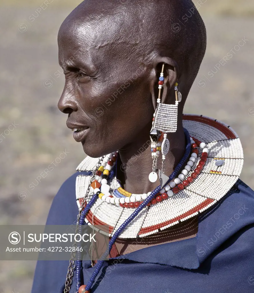 A Maasai woman in traditional attire.  The preponderance of white glass beads in her ornaments denotes that she is from the Kisongo section of the Maasai, the largest clan group, which lives on both sides of the Kenya-Tanzania border.