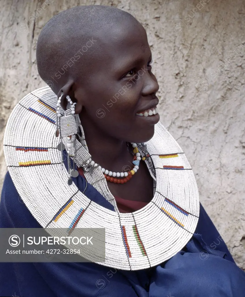 A Maasai woman wearing a very fine beaded necklace.  The predominant white colour of her glass beadwork marks her as a Kisingo Maasai, the largest clan group of her tribe living either side of the Kenya-Tanzania border.