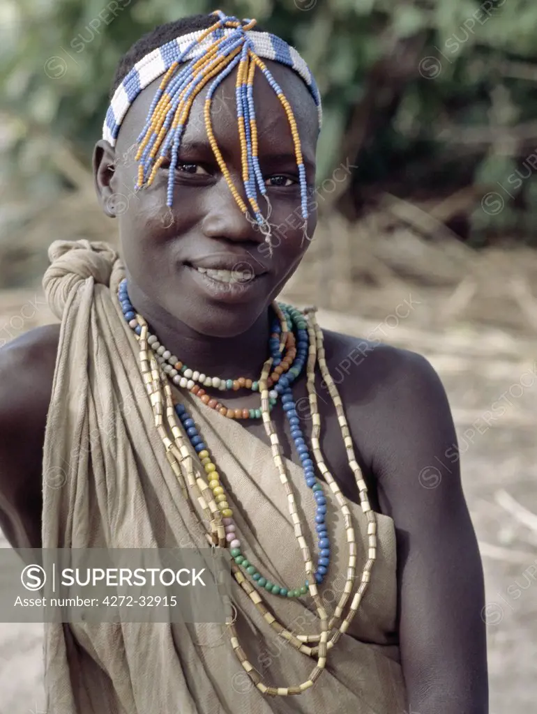 A Hadza girl wearing a beaded headband and necklaces. The Hadzabe are a thousand-strong community of hunter-gatherers who have lived in the Lake Eyasi basin for centuries.  They are one of only four or five societies in the world that still earn a living primarily from wild resources.