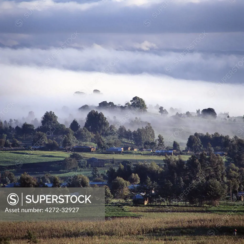 A small market centre near Mbeya is bathed in sunlight as an early morning mist clears from this fertile farming region of Tanzania's Southern Highlands.