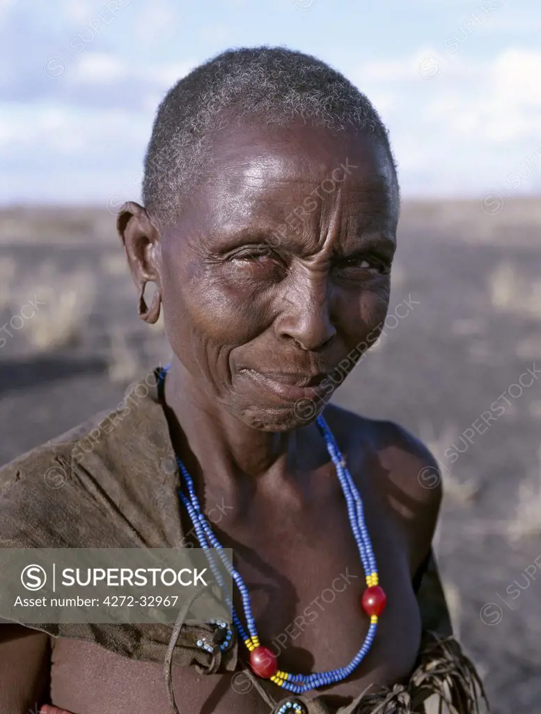 An old Datoga woman. Her traditional attire includes a beautifully tanned and decorated leather dress  The Datoga (known to their Maasai neighbours as the Mang'ati and to the Iraqw as Babaraig)  live in northern Tanzania and are primarily pastoralists.