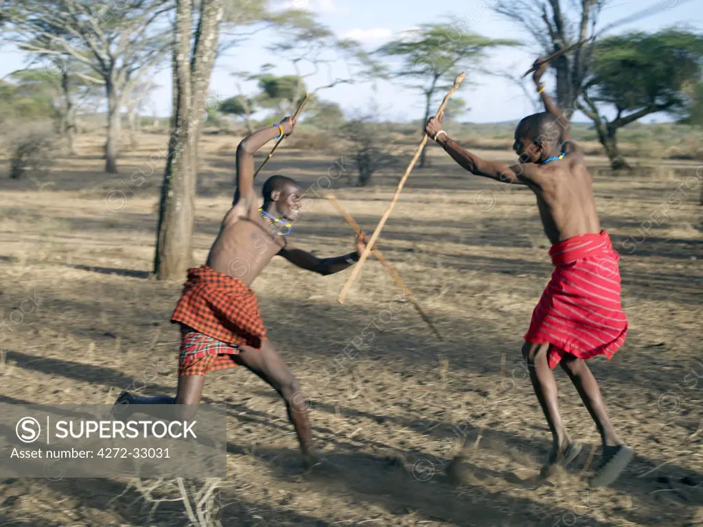 Two Datoga men participate in a mock stick fight. The Datoga (known to their Maasai neighbours as the Mang'ati and to the Iraqw as Babaraig) live in northern Tanzania and are primarily pastoralists.