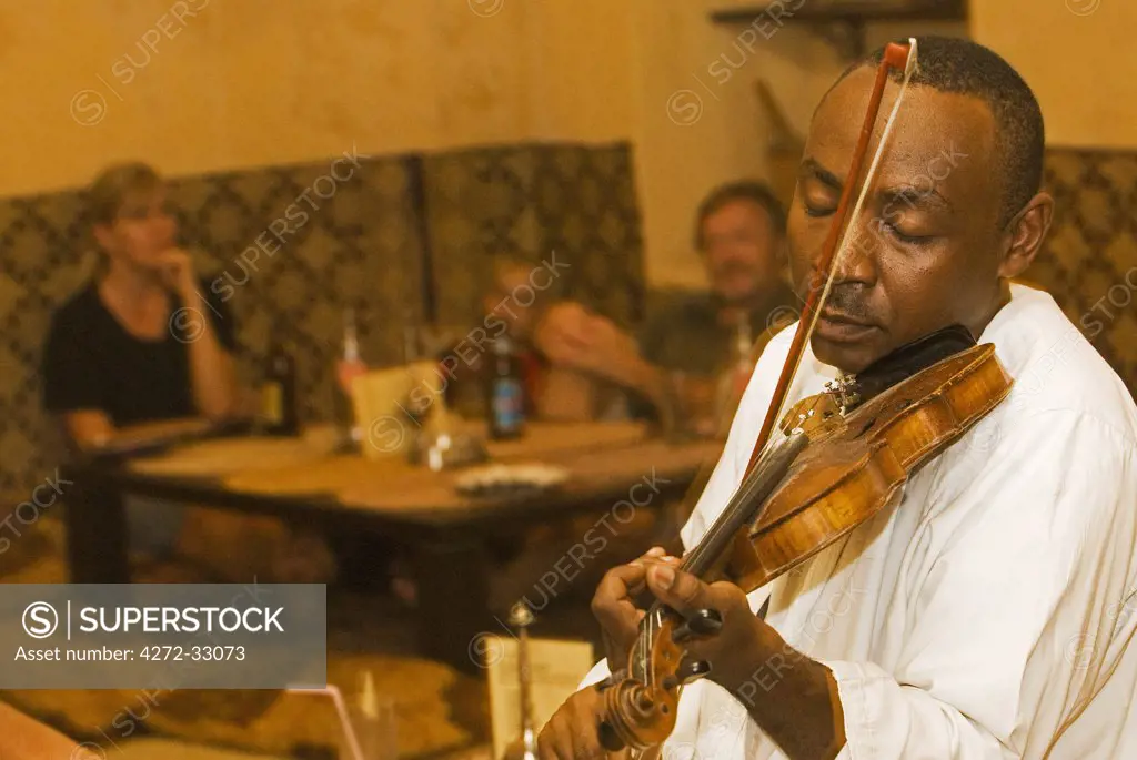 East Africa, Tanzania, Zanzibar. Local Taarab musicians play to guests at the Monsoon Restaurant, Stonetown.