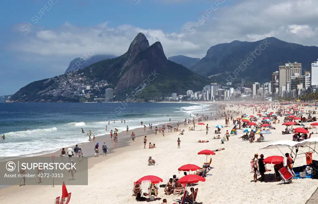 The famous Ipanema Beach in Rio de Janeiro with the Two Brothers Mountain in the background. Brazil