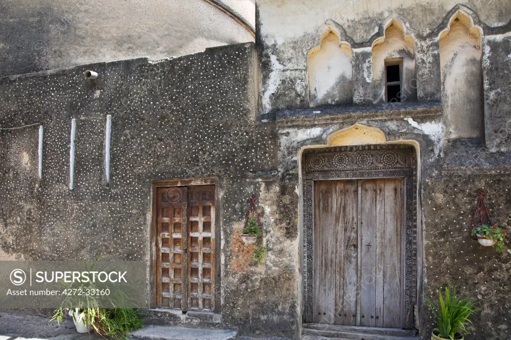 Tanzania, Zanzibar, Stone Town. Old doors and plaster detail of the Anglican Cathedral Church of Christ which had its foundation stone laid on Christmas Day 1873.