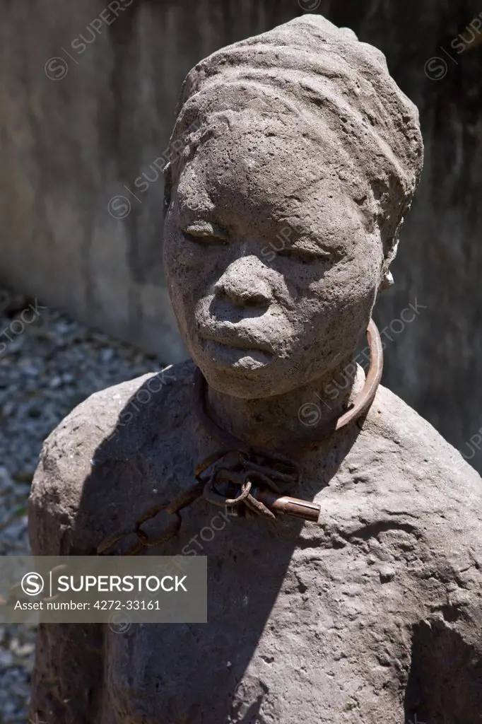 Tanzania, Zanzibar, Stone Town. A poignant reminder of the horrors of the slave trade is depicted in a modern sculpture in the grounds of the Anglican Cathedral Church, the site of the old slave market which closed in 1873.