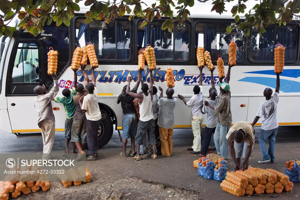 Orange-sellers offer their fruit to passengers on a coach travelling from Dar-es-Salaam to Nairobi.