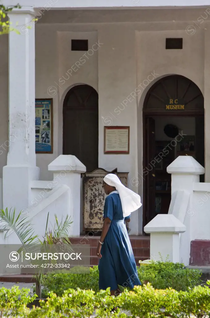 A nun walks past the entrance to the interesting Catholic Museum at the Holy Ghost Catholic Mission in Bagamoyo.