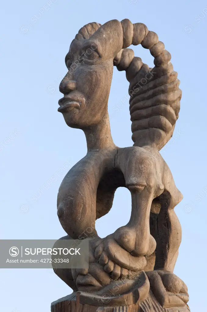 A wood carving which stands on a pillar beside the main entrance to the harbour at Bagamoyo.