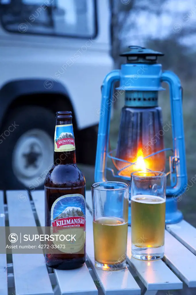 Tanzania, Serengeti. 'It's Kili time!' - Chilled Kilimanjaro beer and a parafin lantern.