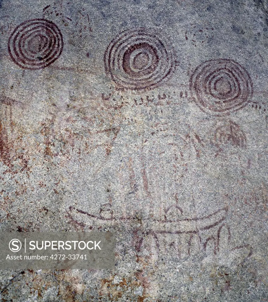 The rock paintings at Nyero in southeast Uganda are among the most interesting in East Africa.  A large shelter wall displays concentric circles and what have been described as 'people sitting in canoes'.  Though damaged by rain seepage, the bold red outlines are clearly visible; however, the chalky white pigment that once filled in these outlines has all but disappeared.