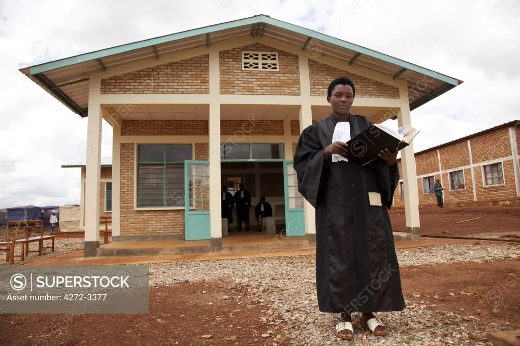 Burundi. A lady judge stands outside her newly built courthouse.