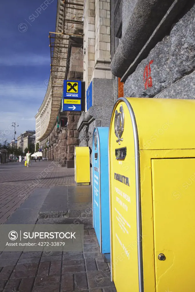 Yellow and blue postboxes outside Central Post Office, Kiev, Ukraine