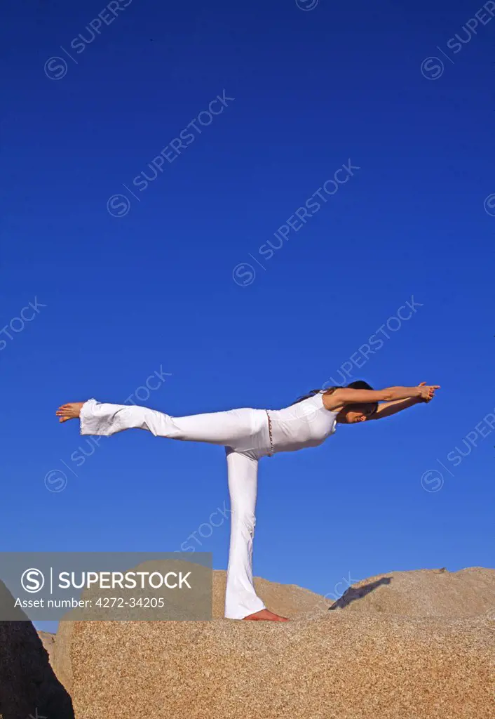 Yoga in the Joshua Tree National Park. This pose is called the 'Virabhadrasana 3' Warrior 3 pose.