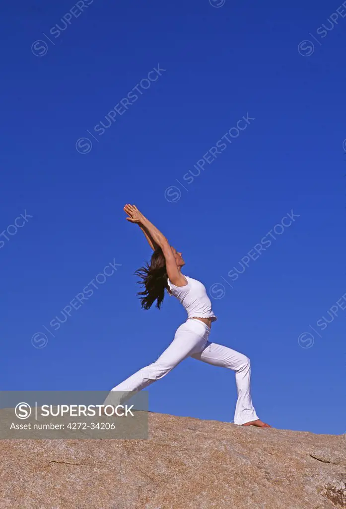 Yoga in the Joshua Tree National Park. The female in this picture is holding the 'Virabhadrasana 1' Warrior 1 pose also known as the estatic warrior as in this pose you can experience a natural feeling of bliss.