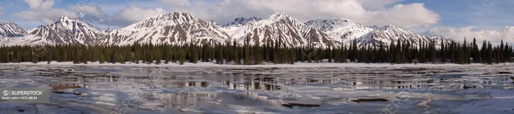 USA, Alaska. Mountains of the Alaska range which are locally called the Craggies. It is late May and the ice on the lake is melting quickly.