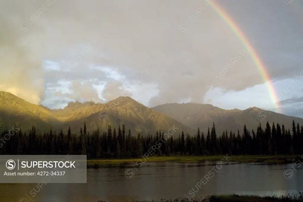 USA, Alaska. A rainbow over Unnamed Mountains in the Alaska Range. Part of the Talkeetna Mountains, locally called the Craggies. About 20 miles south of Cantwell, Alaska.