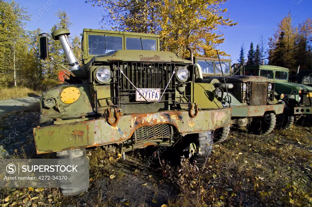 USA, Alaska. Old mining trucks parked at Colorado, an old mining area in the Alaska Range south of Cantwell.
