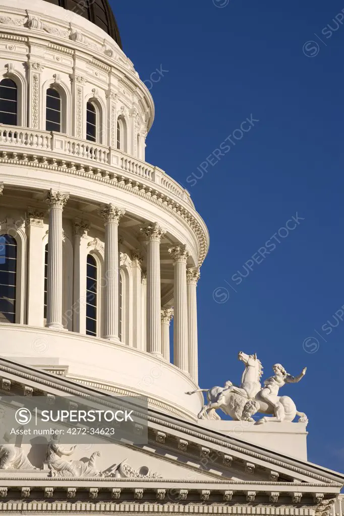 United States, California; Sacramento. Close-up of the State Capitol building showing part of the dome and pediment on the west facade.