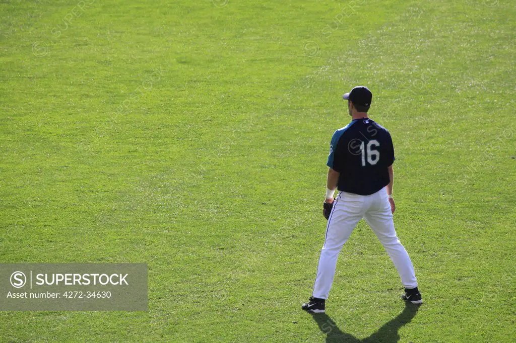 United States of America, Washington, Seattle,A Seattle Mariners baseball player warms up before a match in Safeco Field.