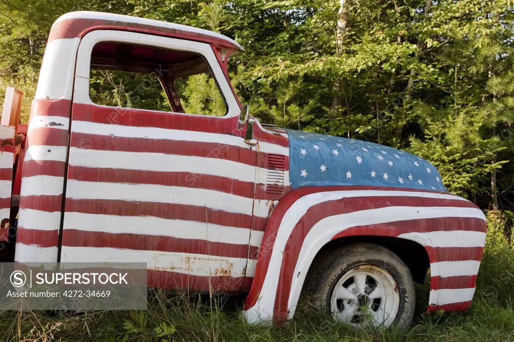 A truck painted with the US flag on a roadside in New Hampshire, USA.