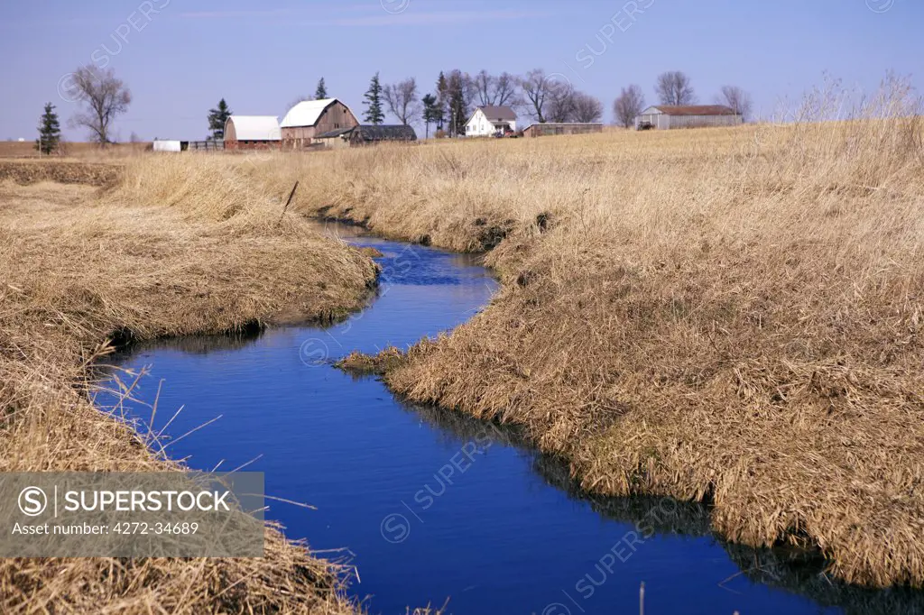 Idaho, USA. A winding creek on a farm in the American Midwest