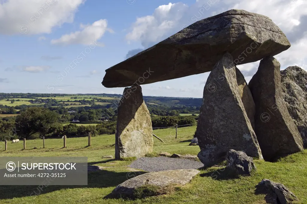 UK, Wales, Pembrokeshire. A young boy visits the site of the ancient neolithic dolmen at Pentre Ifan, Wales's most famous megalith, the remains of a vast Celtic burial mound.