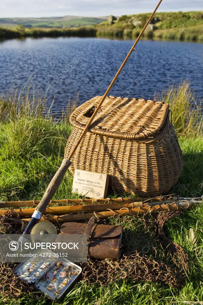 UK, Wales, Conwy. A split-cane fly rod and traditional fly-fishing equipment beside a trout lake in North Wales