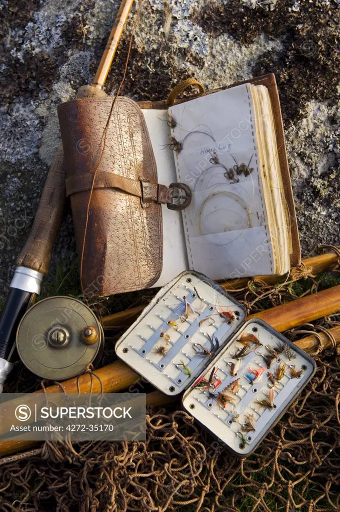 UK, Wales, Conwy. A split-cane fly rod and traditional fly-fishing equipment beside a trout lake in North Wales