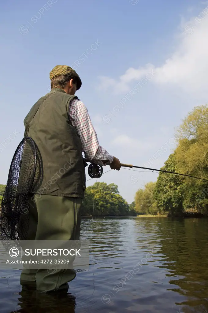 Wales, Wrexham. A fly fisherman salmon fishing on the River Dee (MR)