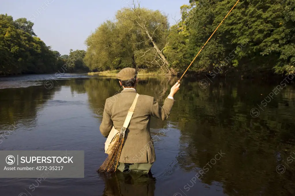 Wales, Wrexham. A trout fisherman casting on the River Dee. (MR)