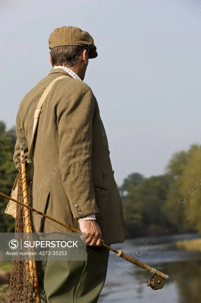 Wales; Wrexham. A trout fisherman surveys the lie of the River Dee (MR)