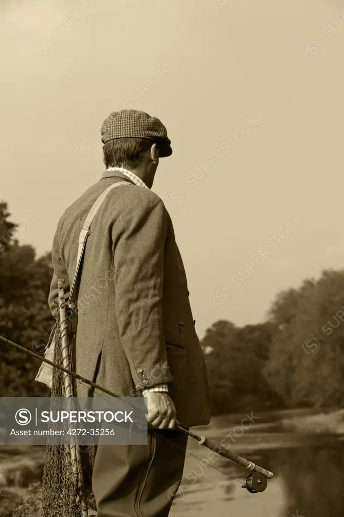 Wales; Wrexham. A trout fisherman surveys the lie of the River Dee (MR)