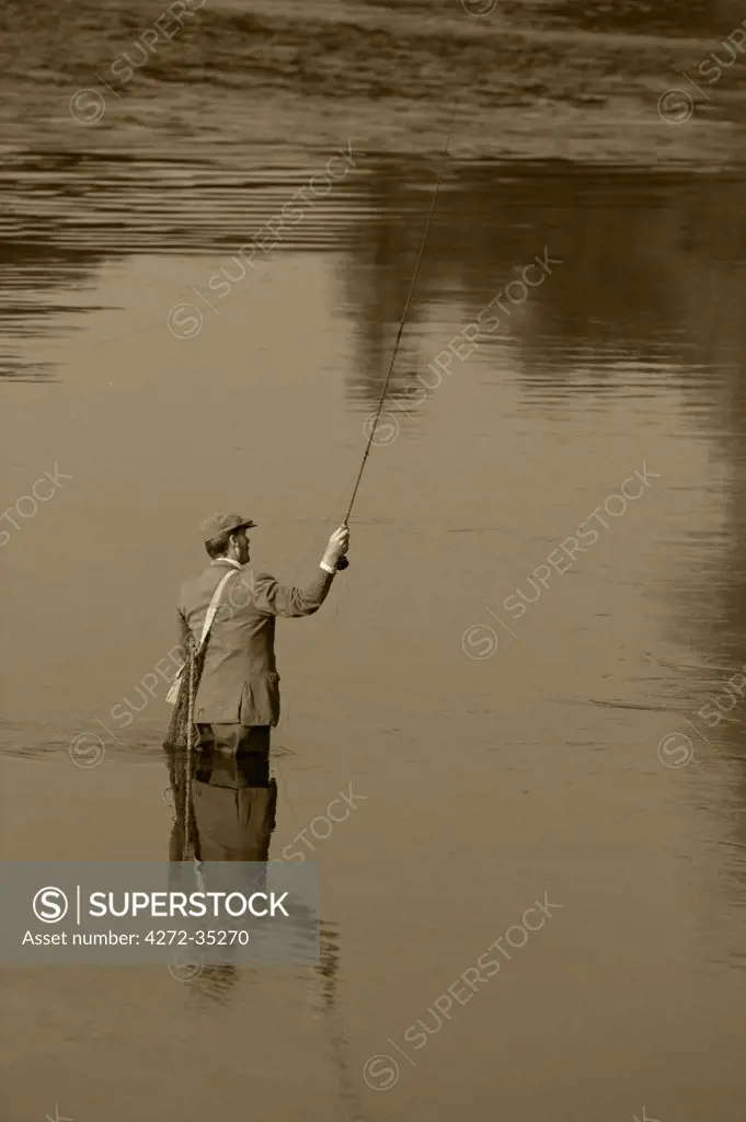 Wales; Wrexham. A trout fisherman casting on the River Dee (MR)