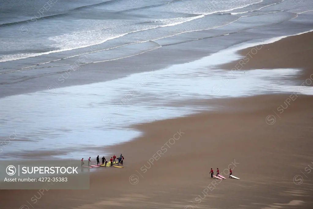 Wales, Gower. Surfers gather for a lesson at Rhossili Bay.