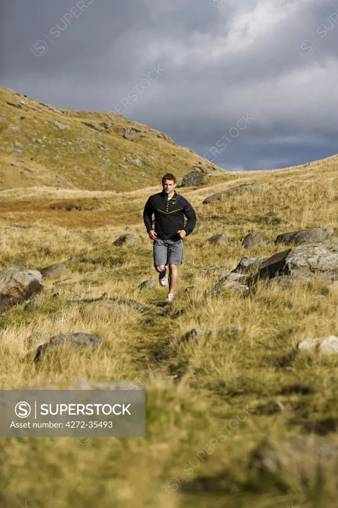 North Wales, Snowdonia.  Man running on the flanks of Mount Snowdon. (MR)