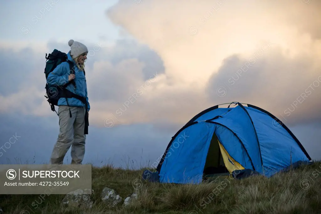 North Wales, Snowdonia, Gilar Farm.  Woman camping in the wild. (MR)
