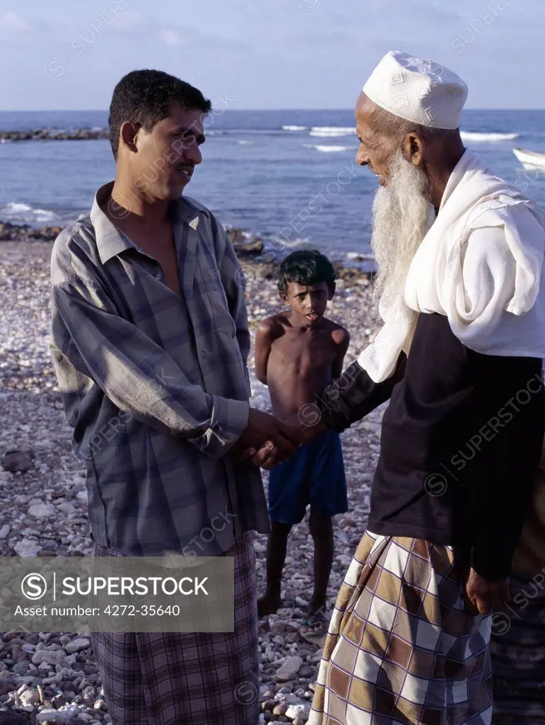 A religious leader talks to a Socotran at Sekra fishing village. Although all Socotrans are now Muslims, this was not the case in years gone by.  Only in the past ten years have women worn the burka.