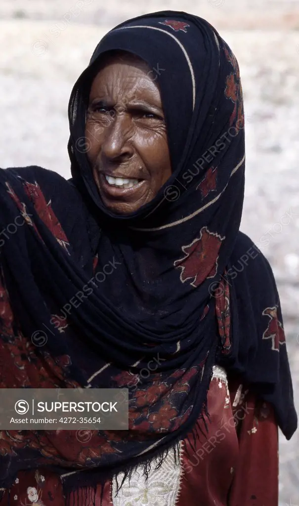An old woman works her family's well in the foothills of the Homhil Mountains. ;All Socotrans are now Muslims, which was not the case in years gone by.  Only in the past ten years have most women taken to wearing the burka.