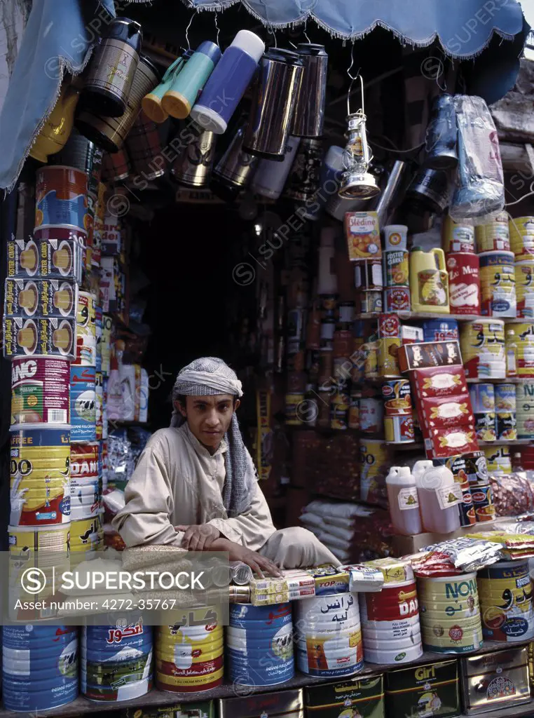 Yemeni trader sells domestic supplies at his stall in old Sanaa.  Surrounded by a massive 20 to 30 foot high wall, old Sanaa is one of the worlds oldest inhabited cities. The suq or central market is located in a labyrinth of streets and alleyways in the centre of the old city.