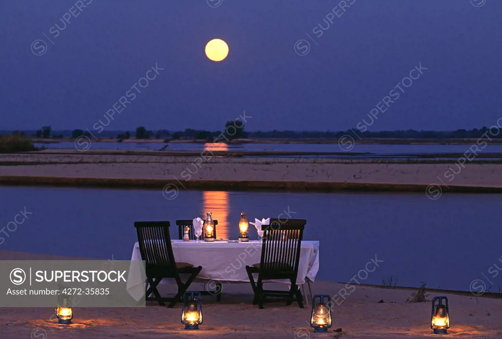 Zambia, Lower Zambesi National Park. Moonlit dinner on an island in the middle of the Zambezi River