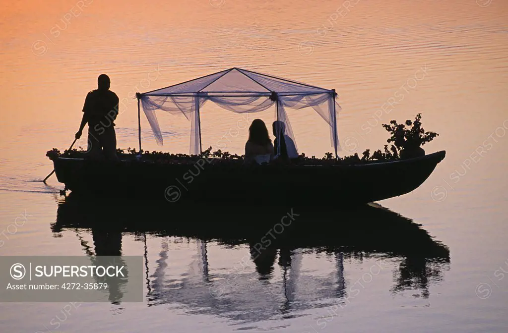 Zambia, South Luangwa National Park. Bush weddings RPS style - bride & groom going away, poled on an African gondola, Nkwali camp.
