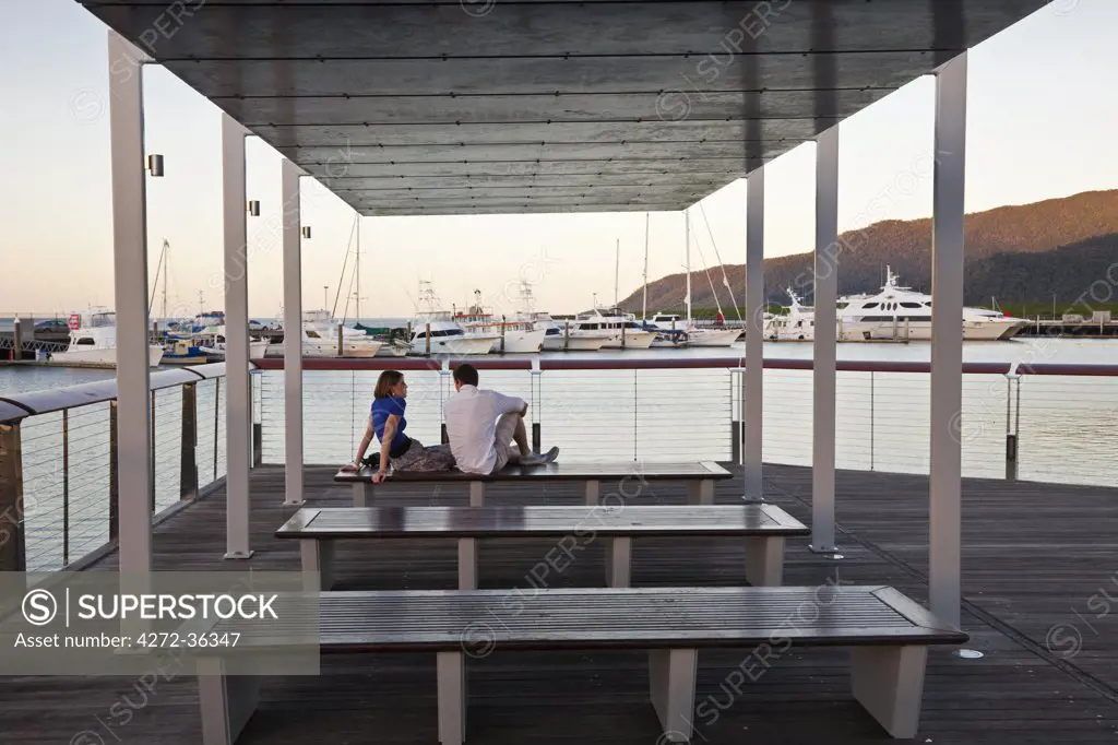 Australia, Queensland, Cairns.  Couple relaxing at Marina Point.