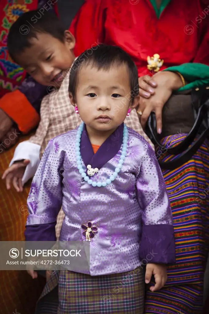 A smartly dressed child watching the masked dancing at Trashi Chhoe Dzong, a monastery now also housing the secretariat, the throne room and offices of the King.