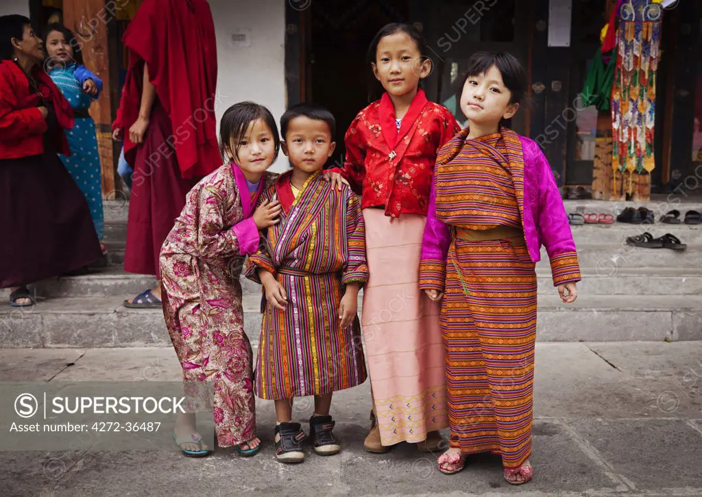Children in traditional Bhutanese dress at the National Memorial Chorten, which was built in the Tibetan style in 1974 to honour the third king of Bhutan.