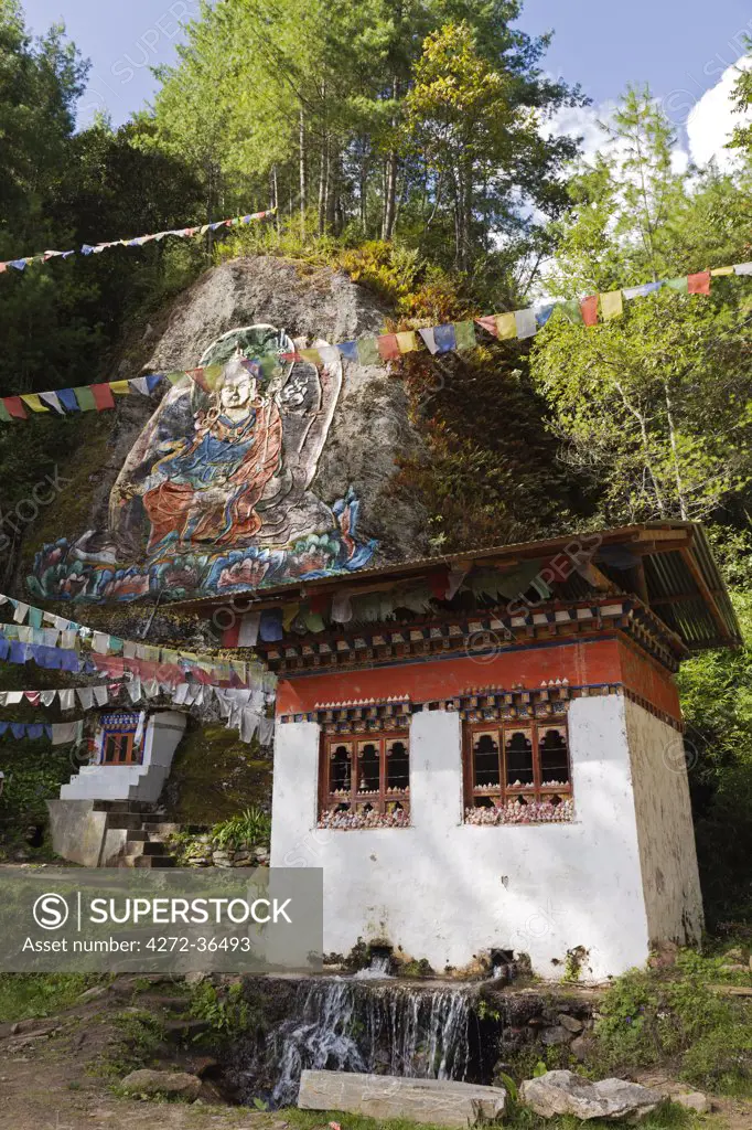 Rock painting of Guru Rinpoche en route to Tango Monastery. On the window ledges of the building sit small sculpture stupa images (tsha tsha) made of clay containing ashes of the cremated dead